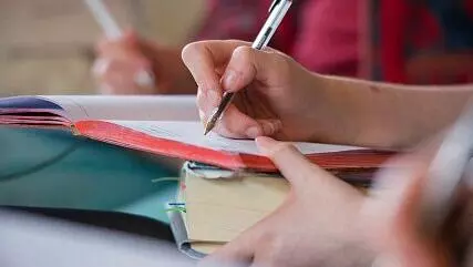Taking notes during a tutorial at New College